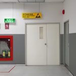 Fire exit way door and fire exit sign lightbox and fire hose in electronic industry ,Green emergency exit sign door direction in case of emergency signage,Fire safety symbol and fire protection.